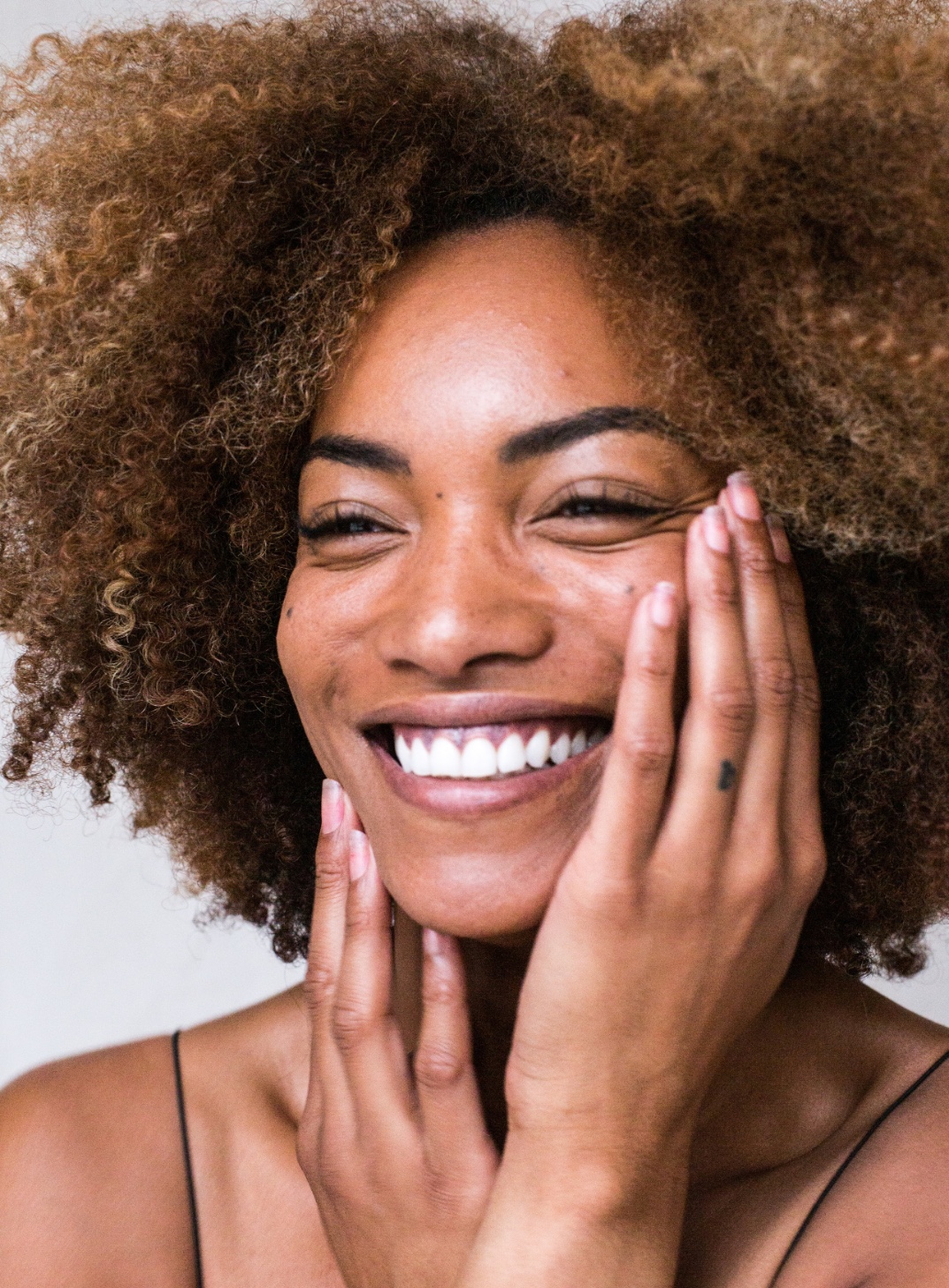 Picture of a model smiling with beautiful skin